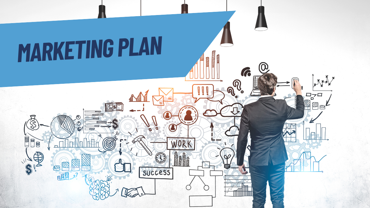 A man in a black suit, writing on a white wall about the key details within the contents of a marketing plan for business.